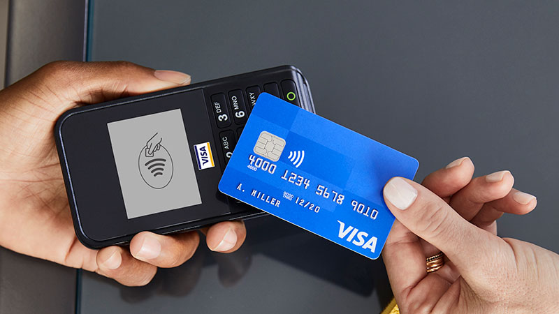 Customer showing a Visa Contactless card to card reader.